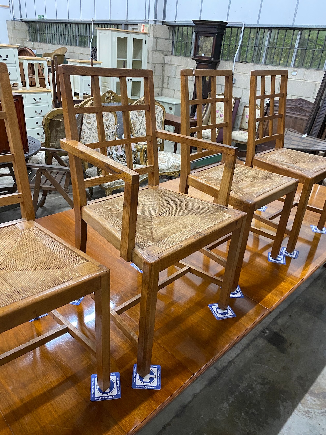 A set of five Heals Cotswold oak dining chairs, including one carver
